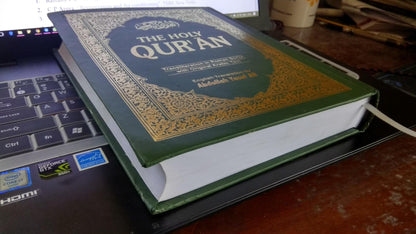 The Holy Qur'an: Transliteration in Roman Script with Arabic Text and English Translation