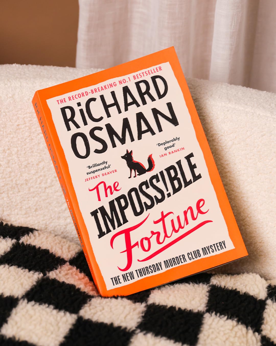 Flat-lay photo of The Impossible Fortune book with coffee cup on table