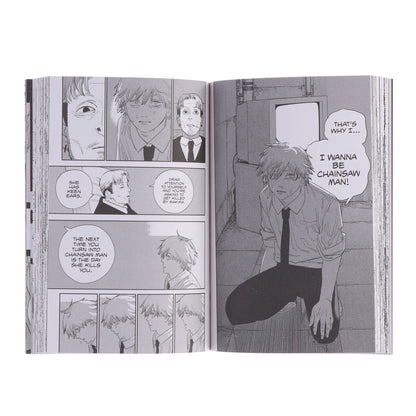 Manga book open to a page with character panels and dialogue bubbles.